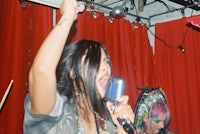 a woman singing into a microphone